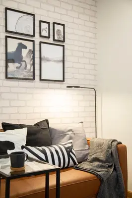 a couch with pillows and a table in a room at Parrish Serviced Apartment in Bang Mote