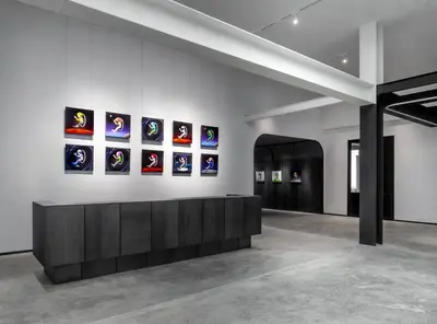 a room with a wall with pictures on the wall at The StandardX, Bangkok Phra Arthit in Bangkok