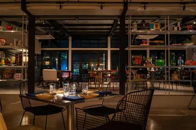 a dining room with a table and chairs at The StandardX, Bangkok Phra Arthit in Bangkok
