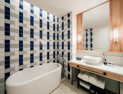 a bathroom with a tub and a sink at The StandardX, Bangkok Phra Arthit in Bangkok