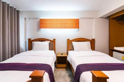 two beds in a hotel room with twothirdsessions at XX GO INN Khaosan Road - Grand Palace in Bangkok