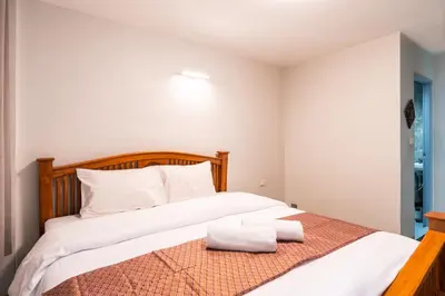 a bedroom with a bed with two towels on it at XX GO INN Khaosan Road - Grand Palace in Bangkok