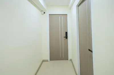an empty corridor with a door in a room at Reezq Hostel in Ban Khlong Bang Sai