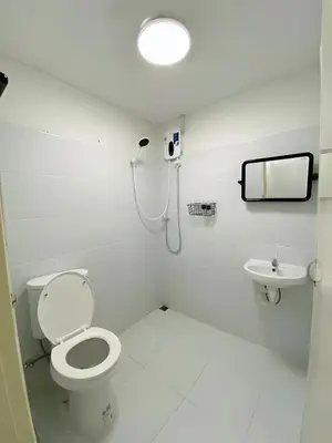 a bathroom with a toilet and a sink at GO INN Siriraj - โกอินน์ ศิริราช Pro in Bangkok Noi