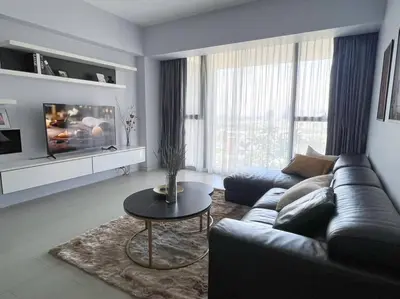 a living room with a couch and a table at Resort Living 2BR - Ultra Fast Wifii - BTS Chong Nonsi in Bangkok