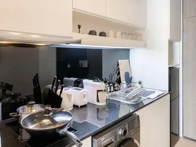a kitchen with a sink and a counter top at Deluxe Suite 1BR Ultra Fast WiFi BTS Thong Lor in Bangkok