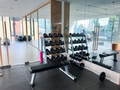 a gym with a bunch of equipment in a room at Transquil Residents 65 SQM - Ultra Fast Wifi - Silom in Bangkok