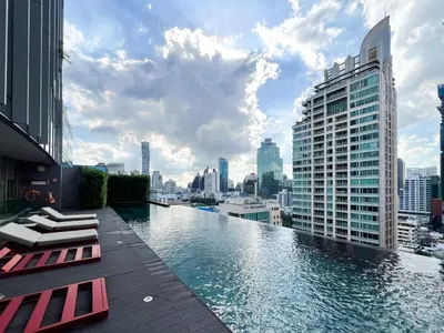 a pool on the roof of a building with a city at Transquil Residents 65 SQM - Ultra Fast Wifi - Silom in Bangkok