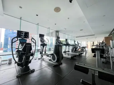 a gym with treadmills and ellipticals in a building at Extravagant Apt 65 sqm 1BR - Ultra Fast Wifi - Silom in Bangkok