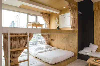 a bedroom with bunk beds and a large window at BOB Hostel सुख सदन ひだまり庵 파란달여관 in Bangkok
