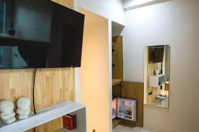 a room with a flat screen tv on a wall at BOB Hostel सुख सदन ひだまり庵 파란달여관 in Bangkok