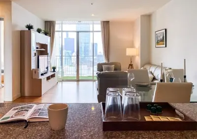 a living room with a couch and a table at Downtown View 65 SQM - Ultra Fast Wifi - Sathorn in Bangkok