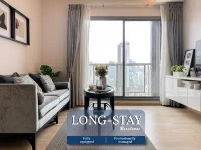 a living room with a couch and a table at Stylish Modern 1BR - BTS Phrom Phong - Ultra Fast WiFi in Bangkok
