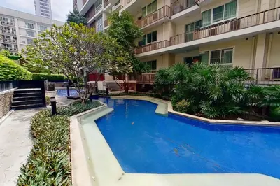 a large blue swimming pool in front of a building at Exclusive Modern Apt - Ultra Fast WiFi - Thong Lo in Bangkok