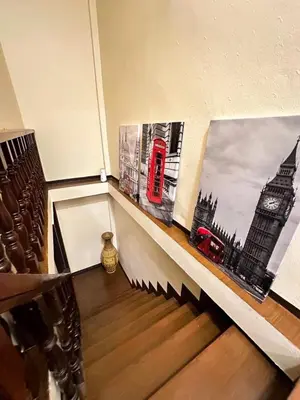 a room with two pictures of a red phone booth at Twenty-one BKK House in Bang Kapi