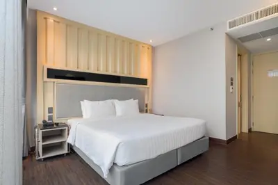 a bedroom with a large white bed in a room at T2 The Portal Sukhumvit in Bangkok