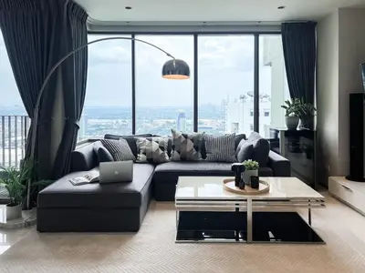 a living room with a couch and a table at The Grand Penthouse 2BR Ultra Fast WiFi Sukhumvit in Bangkok
