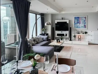 a living room with a couch and a tv at The Grand Penthouse 2BR Ultra Fast WiFi Sukhumvit in Bangkok