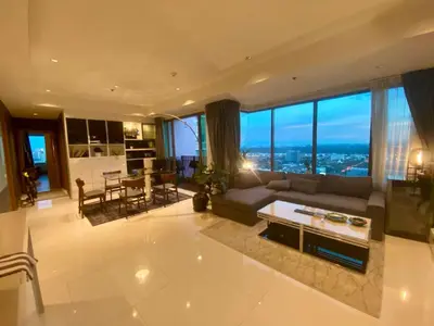 a large living room with a couch and a table at The Grand Penthouse 2BR Ultra Fast WiFi Sukhumvit in Bangkok