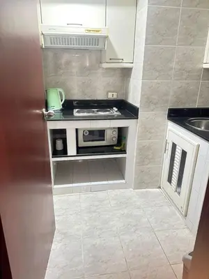 a small kitchen with a sink and a stove at Rent Omni Tower Apartments Nana Bangkok - Prime Sukhumvit location in Bangkok