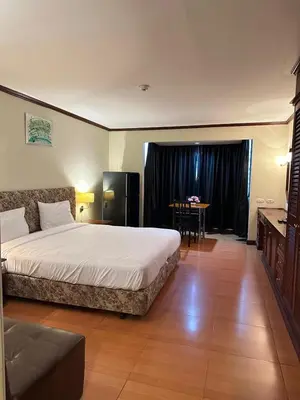 a hotel room with a bed and a table at Rent Omni Tower Apartments Nana Bangkok - Prime Sukhumvit location in Bangkok