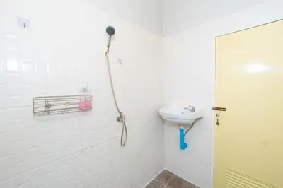 a bathroom with a shower and a sink at Tom Guest House ทอมส์ เกสต์เฮ้าส์ in Thung Maha Mek