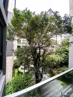 a tree on the side of a building with stairs at Tropical Apartment- Ultra Fast WiFi- BTS Thong Lor in Bangkok