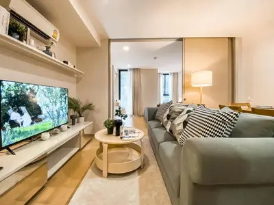 a living room with a couch and a large tv at Tropical Apartment- Ultra Fast WiFi- BTS Thong Lor in Bangkok
