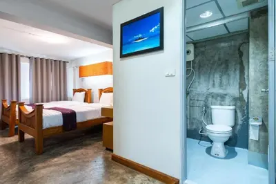 a hotel room with a bed and a toilet at XX GO INN Khaosan Road BKK - Grand Palace in Bangkok