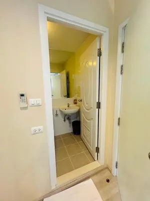 a bathroom with a sink and a white door at Minimal 2 BR next to IKEA, Central Westgate Bangyai in Ban Bang Krabu