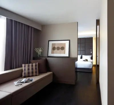 a living room with a couch and a bed at Happy 3 in Bangkok