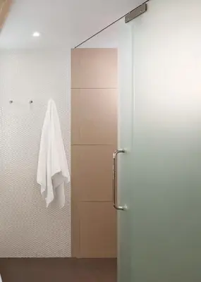a bathroom with a shower with a white towel at Happy 3 in Bangkok
