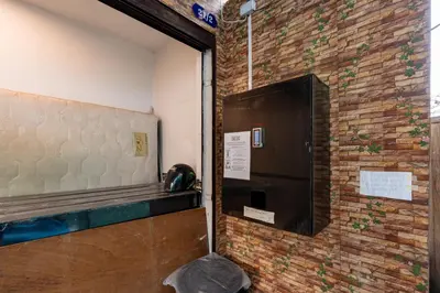 a door in a room with a brick wall at xx The Hidden Sao Chingcha - เดอะ ฮิดเด้น เสาชิงช้า in Bangkok