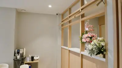 a room with a vase of flowers on a wall at The Staytion Hotel at Sukhumvit in Amphoe Phra Khanong