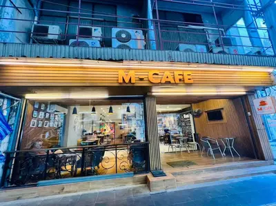 a store front of a me cafe with tables and chairs at Cozy Spacious 55sqm 1BR 200m BTS PhraKhanong, 10min Thonglo in Bangkok