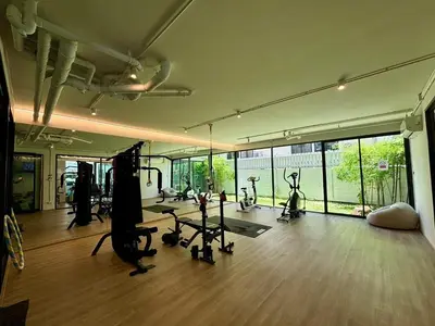 a gym with treadmills and exercise bikes in a room at 5 mins to Ari - Sutthisan in Bang Su