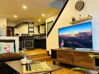 a living room with a large screen tv and a chessboard at 7 Beds Villa Emquartier BtsThonglor Phrom phong in Bangkok