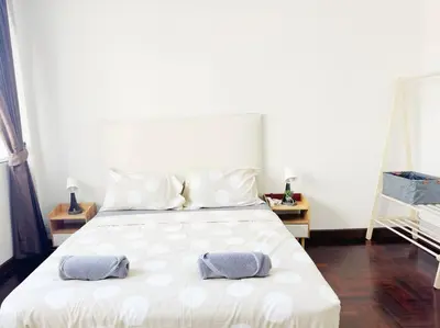 a bedroom with a white bed with two pillows on it at 5BR House 8Beds, Ekkamai BTS 12mins walk, 711, shopping mall in Bangkok