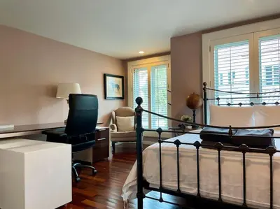 a bedroom with a bed and a desk and a chair at Sukhumvit 16 Townhouses, InHome Luxury Residences in Bangkok