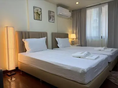 a bedroom with a large bed with two towels on it at Apamet Hotel Sukhumvit 55 in Khlong Toei
