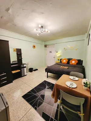 a bedroom with a bed and a table and a desk at 807-STP Homely room Free Wi-Fi and Near BTS line in Ban Yang