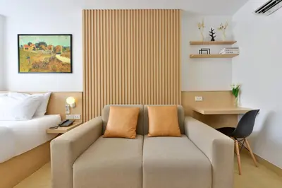 a hotel room with a couch and a bed at V32 Hotel in Ban Zong Katiam