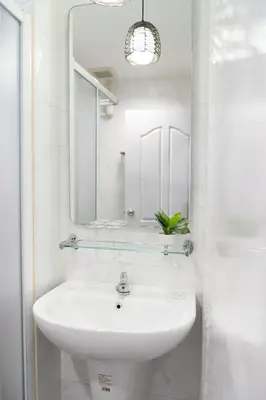a white bathroom with a sink and a mirror at Pillow BKK Bliss townhome 5BR,7TL near BTS&MRT QSCC in Khlong Toei