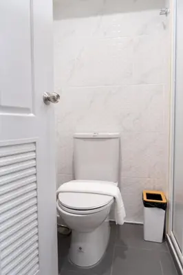 a bathroom with a toilet with a towel on it at Pillow BKK Bliss townhome 5BR,7TL near BTS&MRT QSCC in Khlong Toei