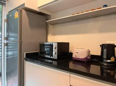 a kitchen with a microwave and a toaster on a counter at 3BR Sukhumvit Townhouse, close to Emsphere and BTS MRT in Bangkok