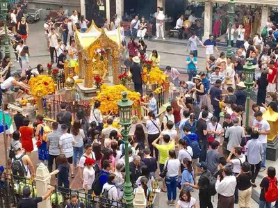 a crowd of people standing in a street with a temple at 3BR Sukhumvit Townhouse, close to Emsphere and BTS MRT in Bangkok