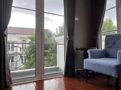 a room with a chair and a large window at 3BR Sukhumvit Townhouse, close to Emsphere and BTS MRT in Bangkok