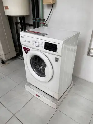 a washing machine sitting on a stand in a room at 3BR Sukhumvit Townhouse, close to Emsphere and BTS MRT in Bangkok