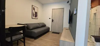 a living room with a couch and a table at The Chapter One Lifestyle Condo in Bang Khen