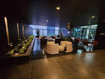 a lobby with chairs and tables in a building at 1BR at ThongLor BTS overlooking city with Workspace in Bangkok